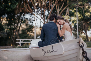 bride and groom sitting in a boat